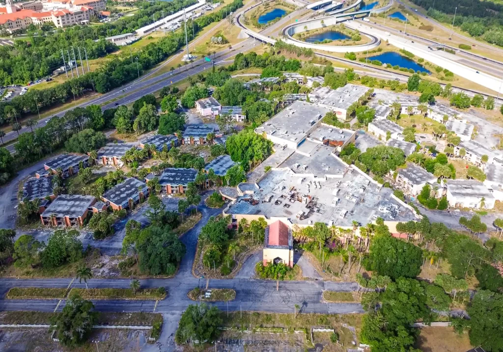 the eerie remains of the abandoned Orlando Sun Resort, once a bustling hotel near Disney World, now a decaying time capsule explored by urban explorer Freaktography.