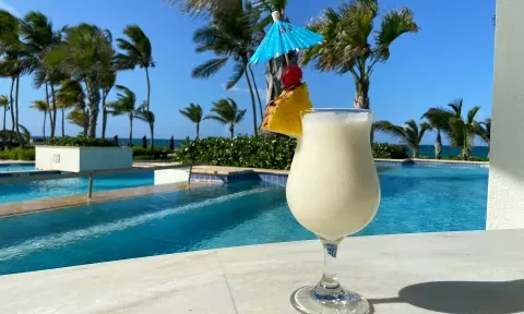 A Hilton survey reveals 96% of Americans feel relaxed with a Piña Colada, yet only 35% order it outside vacation. Discover why this tropical drink is a holiday favorite.