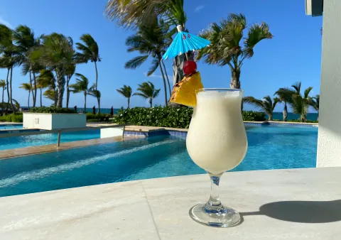 A Hilton survey reveals 96% of Americans feel relaxed with a Piña Colada, yet only 35% order it outside vacation. Discover why this tropical drink is a holiday favorite.