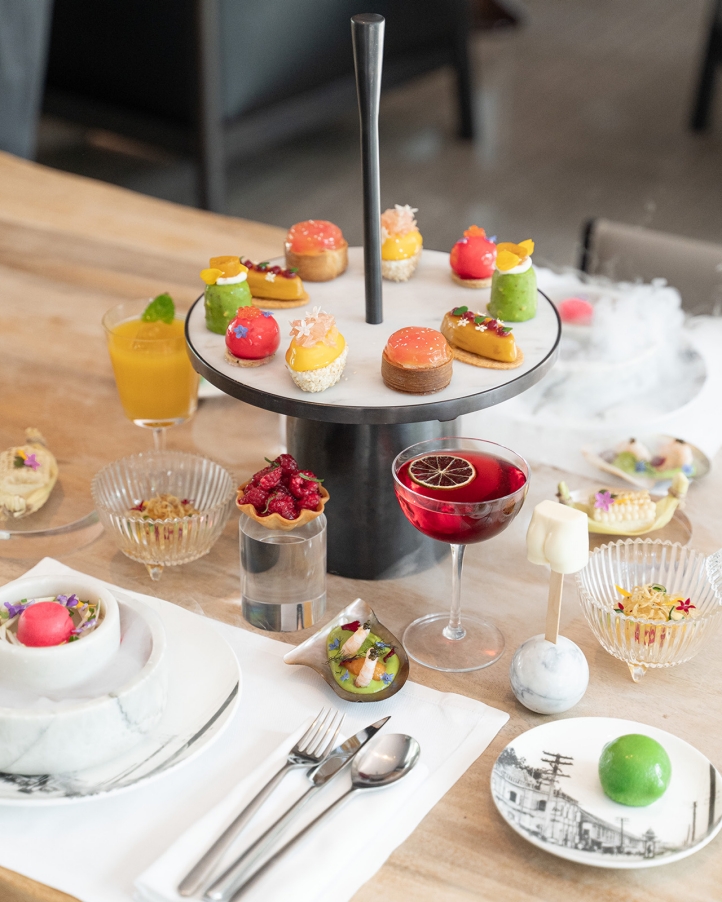 Indulge in the *Citrus Breeze Afternoon Tea* at The Lounge, Four Seasons Hotel Bangkok, featuring refreshing citrus-inspired flavors and delicacies crafted by Executive Pastry Chef Andrea Bonaffini.