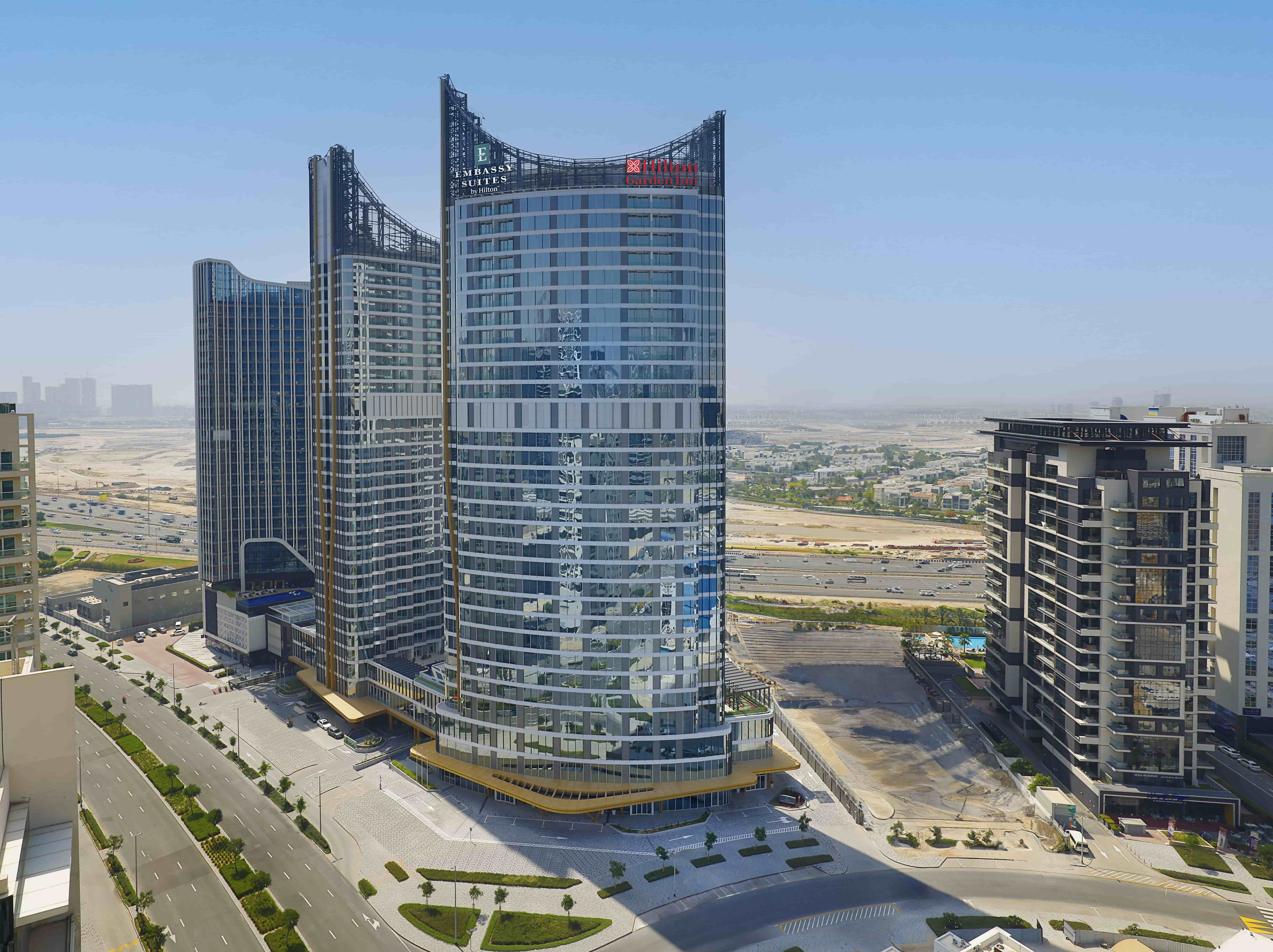 Hilton expands its UAE portfolio with the debut of Embassy Suites by Hilton and the opening of Hilton Garden Inn in Dubai Business Bay, offering luxury accommodations and prime city access.