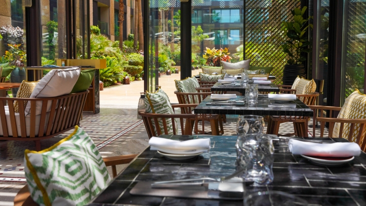 Kyúb at Four Seasons Hotel Casablanca offers a luxurious dining experience with coastal cuisine and Latin American influences, crafted by Chef Aleksandr Gaitsuk in a serene garden setting.