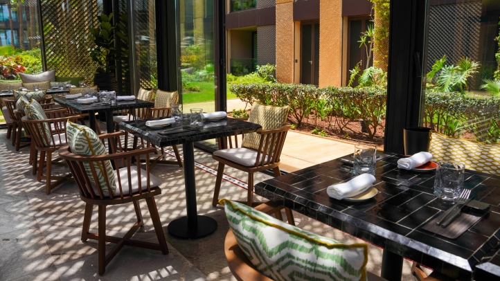 Kyúb at Four Seasons Hotel Casablanca offers a luxurious dining experience with coastal cuisine and Latin American influences, crafted by Chef Aleksandr Gaitsuk in a serene garden setting.