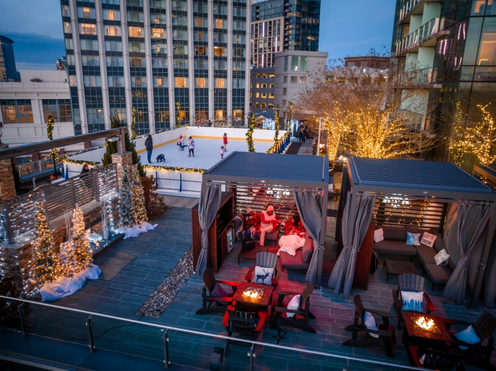 Experience festive cheer at Four Seasons Hotel Baltimore's Winter Village, featuring a rooftop skating rink, seasonal treats, cozy cabanas, and stunning harbor views.