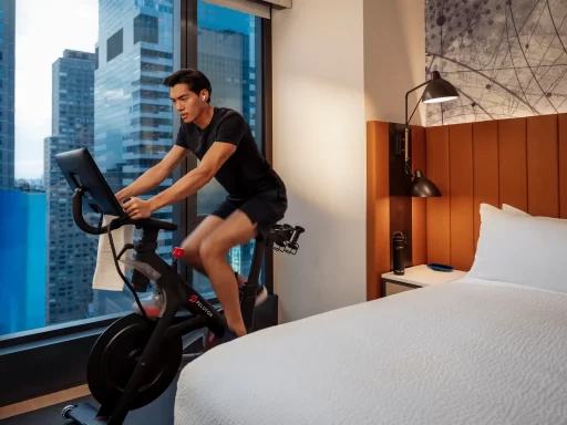 Hilton and Peloton partner to offer in-room fitness classes via Connected Room, letting travelers maintain wellness routines with on-demand yoga, cardio, strength, and more.